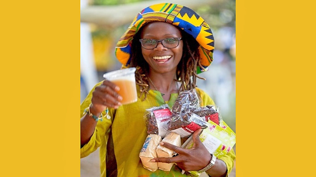 Participant holding drink and food items bought at Sept 2024 festival