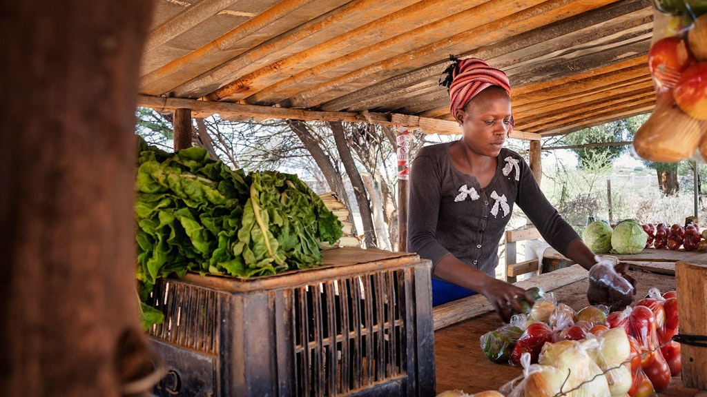 Woman at market selling vegetables
